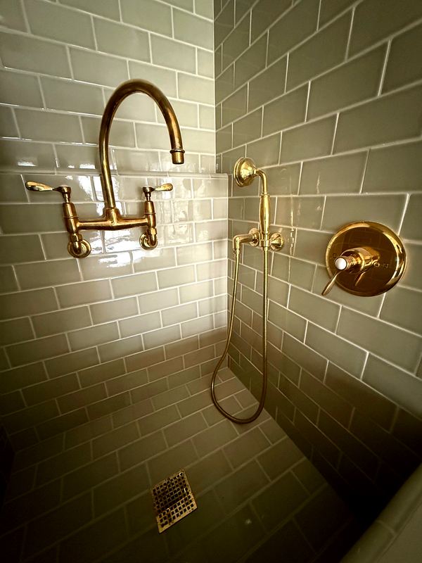 Handmade subway tile and unlacquered brass