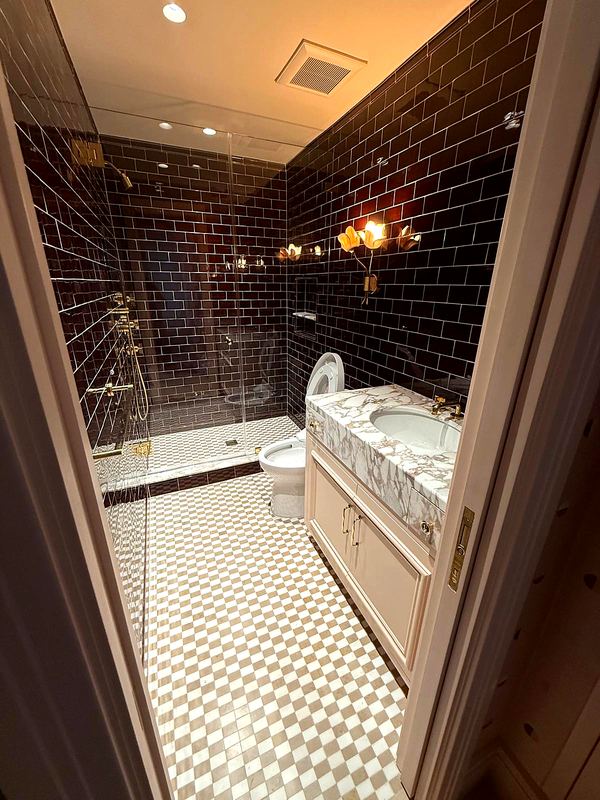 Guest bath with glazed tile and checkerboard floor