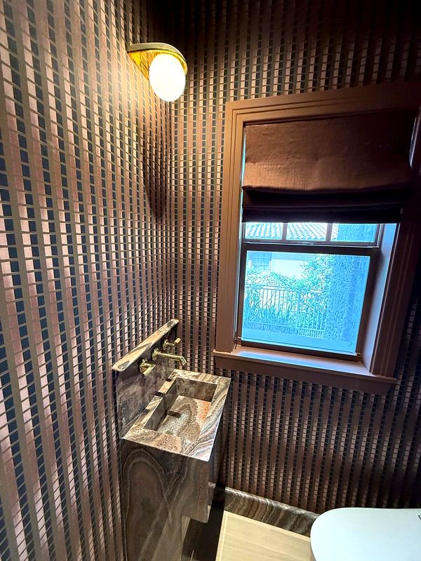 Powder room with a carved onyx sink